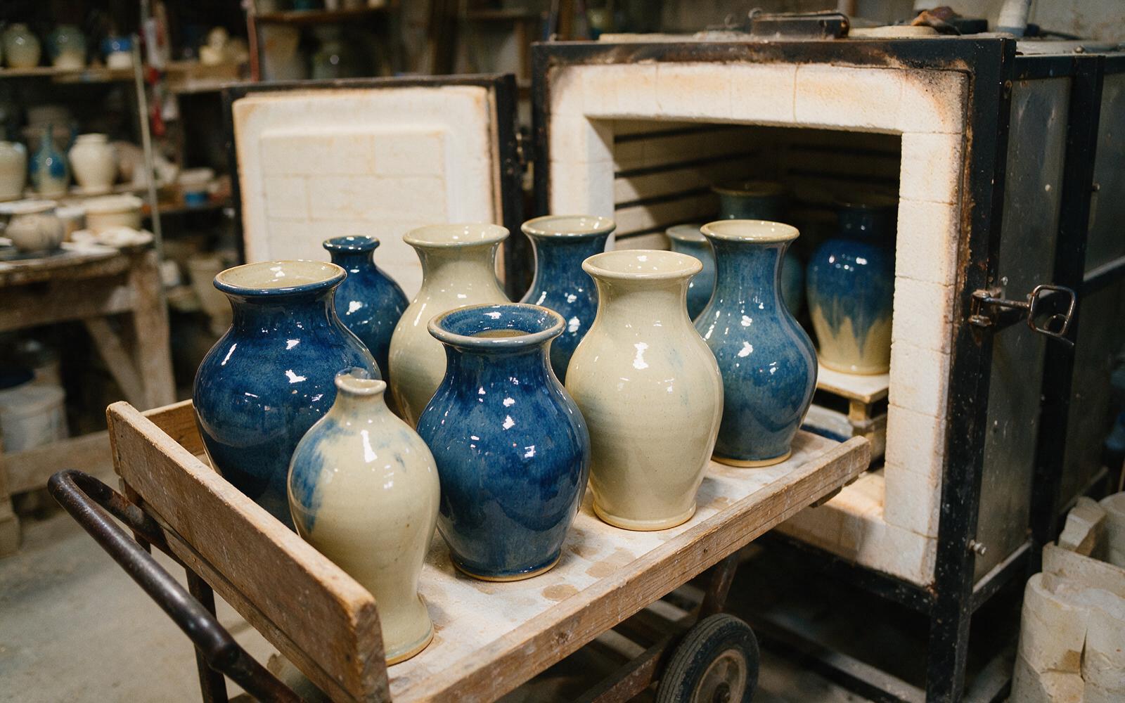 Finished vases cooling on a cart after the kiln is opened